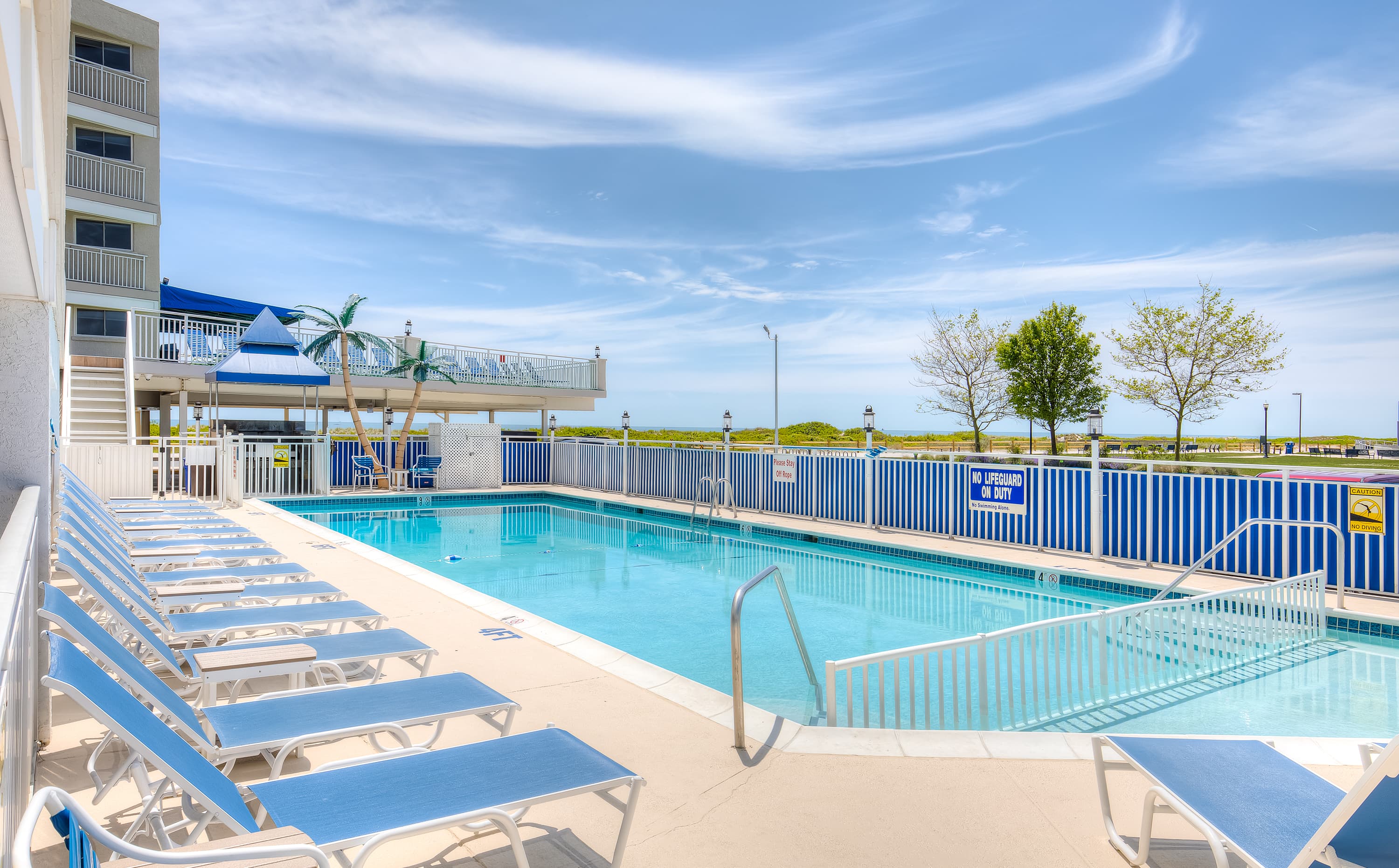 Walk out to a sunny view of the pool